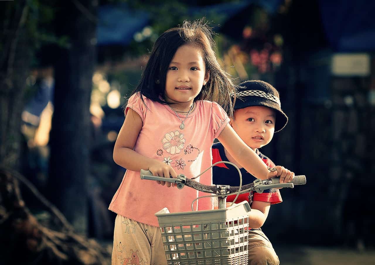 Asian toddlers on a bike
