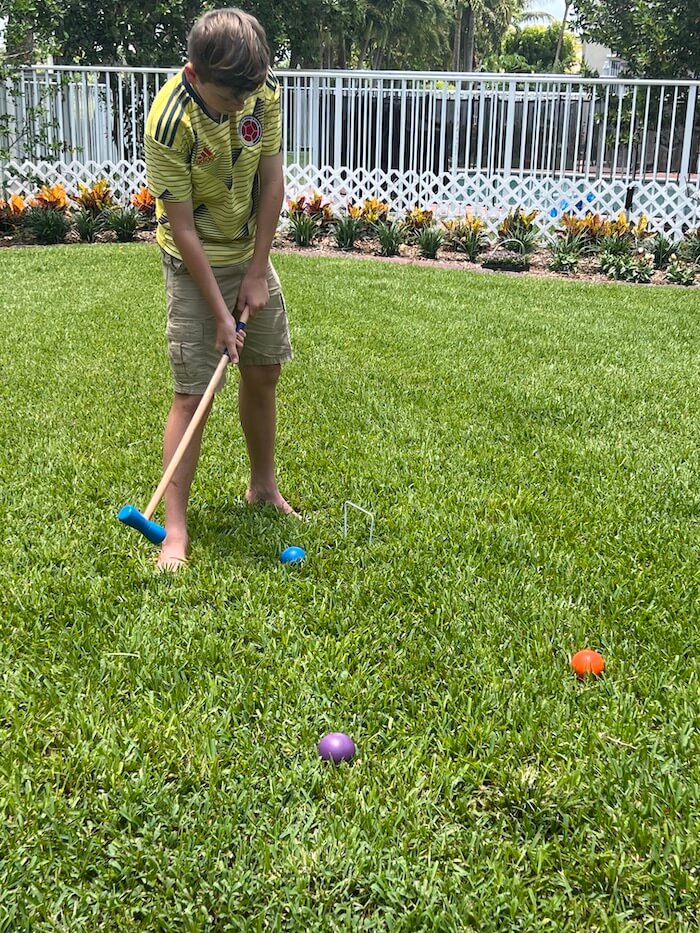 boy playing croquet