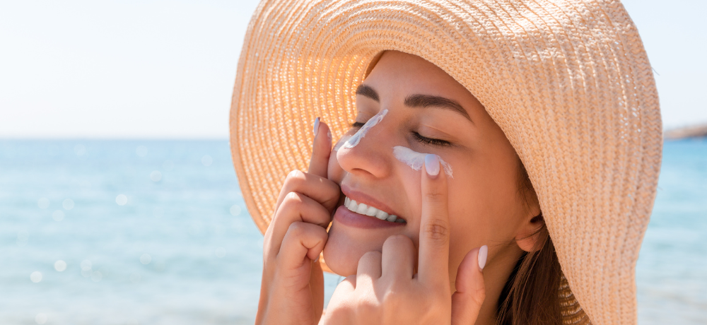 woman applying sunscreen to her face