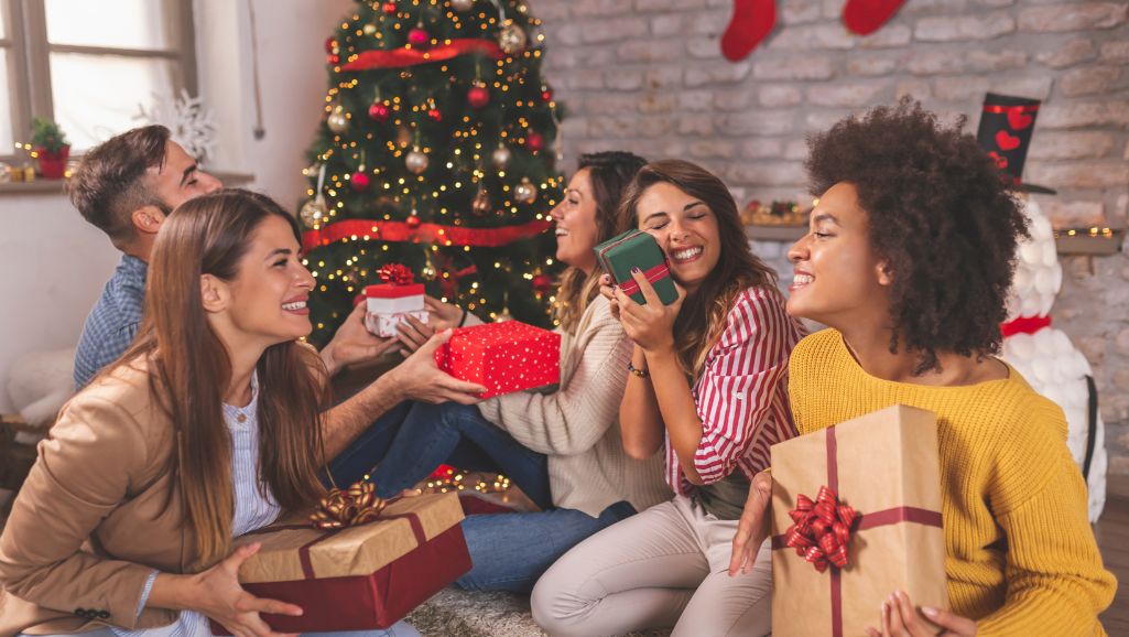 women unwrapping gifts