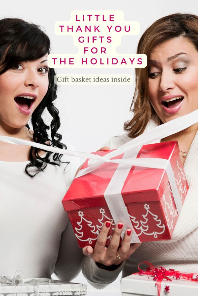 Menopause holiday gift ideas: two women excited to unwrap a red gift box with a white ribbon and Christmas tree print