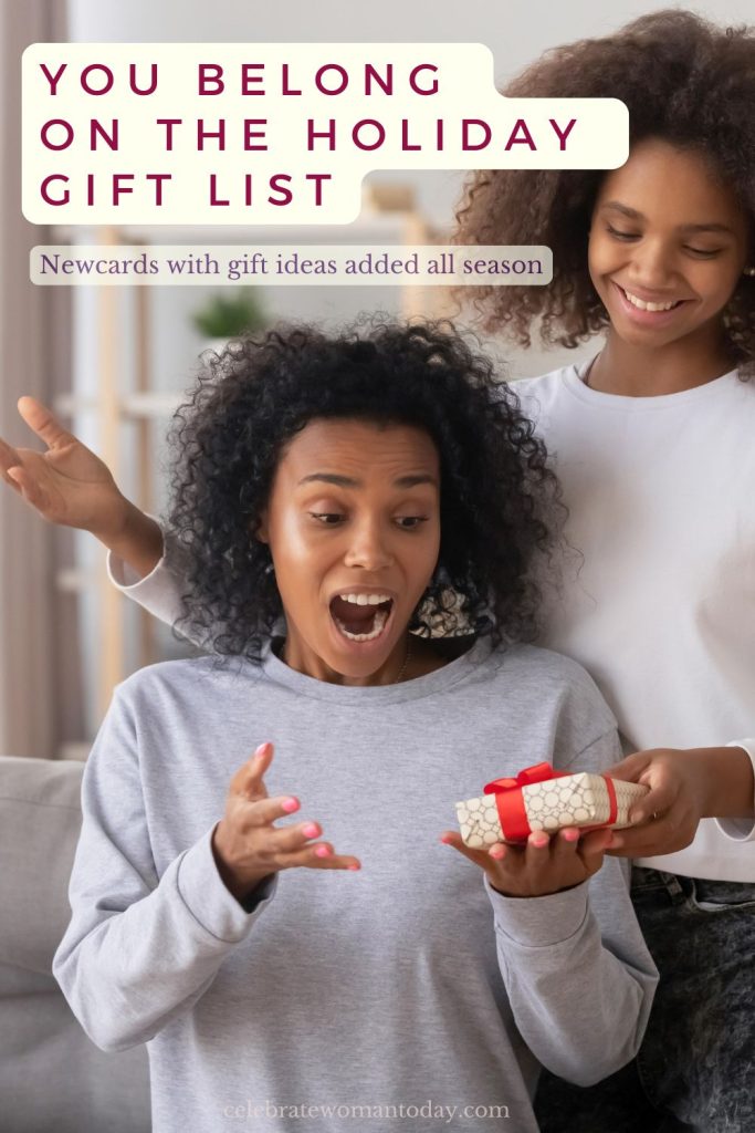 Holiday gift ideas for menopause: woman gasping with delight as a younger person hands her a small wrapped gift